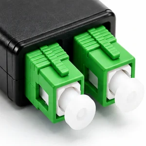 Close-up of two green SC/APC fiber optic loopback connectors with push-pull latches and protective dust caps